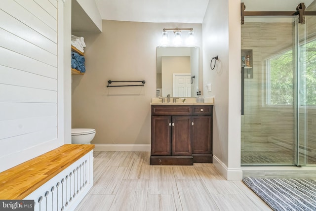full bath featuring baseboards, a stall shower, toilet, and vanity