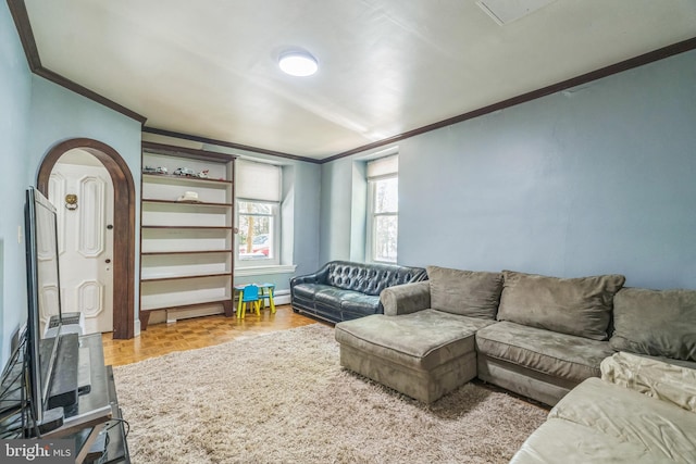 living room featuring crown molding, arched walkways, and baseboards
