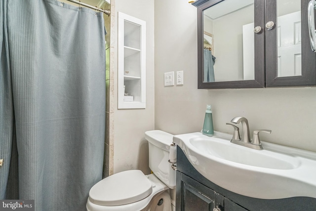 full bathroom with toilet and vanity