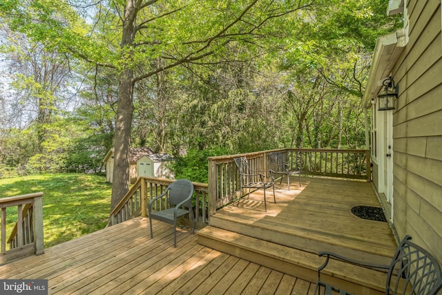deck featuring a storage shed, an outdoor structure, and a lawn