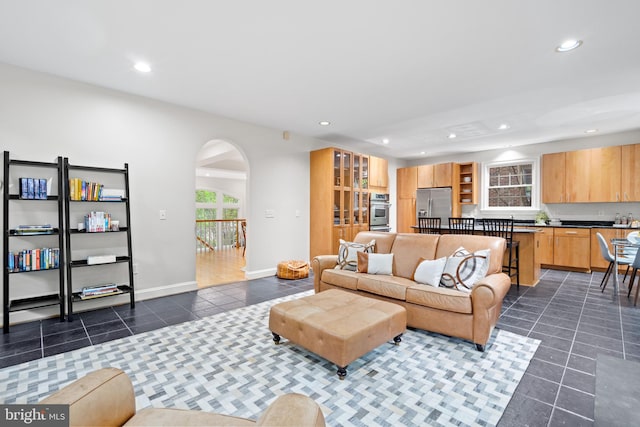 3929 Vacation Ln, Arlington, VA 22207 - living area featuring dark tile patterned floors, recessed lighting, baseboards, and arched walkways
