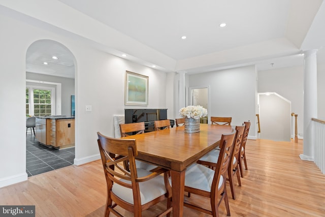 3929 Vacation Ln, Arlington, VA 22207 - dining area featuring light wood-style floors, recessed lighting, arched walkways, decorative columns, and baseboards
