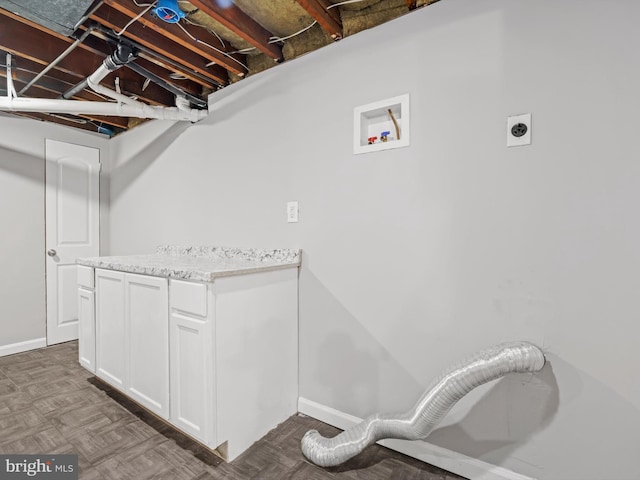 clothes washing area featuring cabinet space, hookup for an electric dryer, and hookup for a washing machine