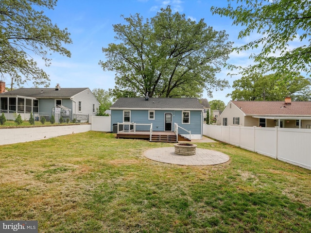 rear view of house featuring a yard, a deck, a fire pit, and fence private yard