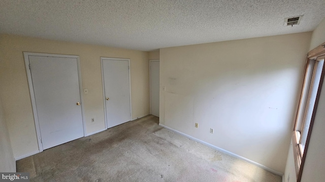 815 Ravens Crest Dr, Plainsboro, NJ 08536 - unfurnished bedroom featuring carpet floors, a textured ceiling, multiple windows, and baseboards