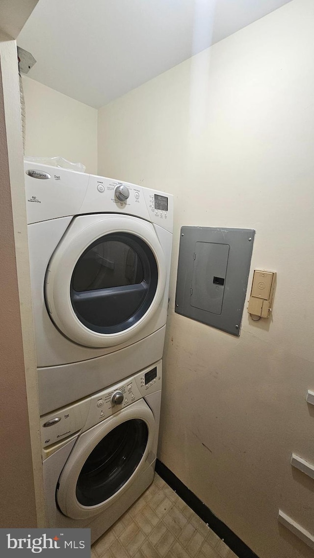 815 Ravens Crest Dr, Plainsboro, NJ 08536 - washroom featuring stacked washer and clothes dryer, tile patterned floors, electric panel, and baseboards