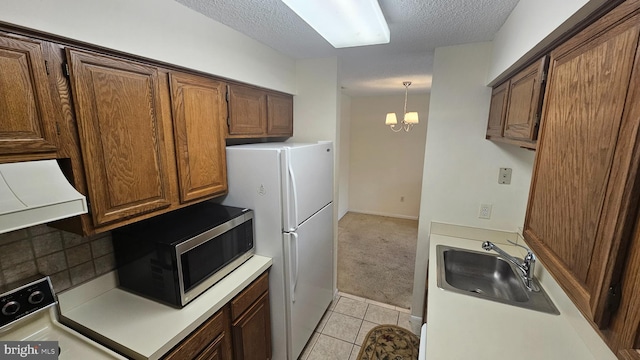 815 Ravens Crest Dr, Plainsboro, NJ 08536 - kitchen with stainless steel microwave, a sink, extractor fan, stove, and freestanding refrigerator
