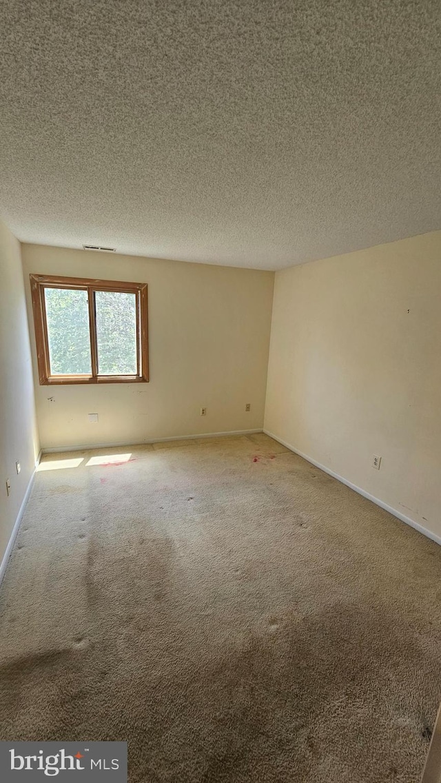815 Ravens Crest Dr, Plainsboro, NJ 08536 - empty room featuring carpet floors, a textured ceiling, and baseboards