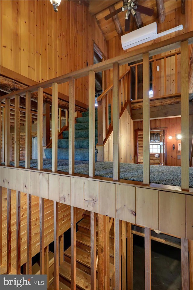 misc room featuring wood walls and ceiling fan