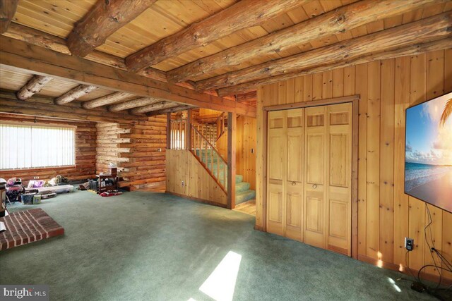 miscellaneous room featuring wooden ceiling, carpet floors, stairway, and beamed ceiling