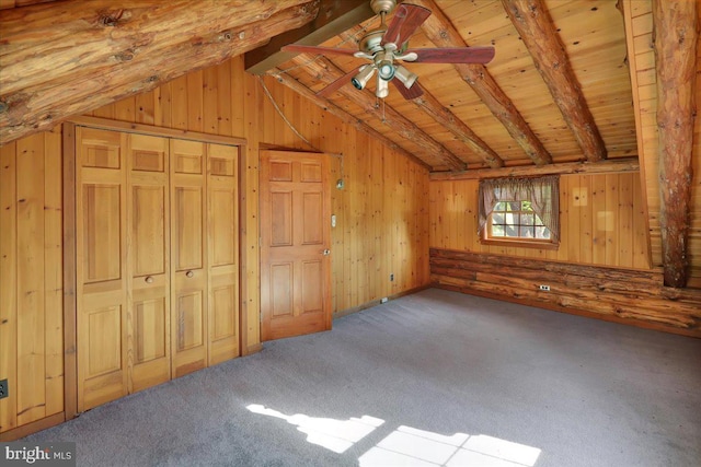 bonus room with wooden walls, vaulted ceiling with beams, carpet, and ceiling fan
