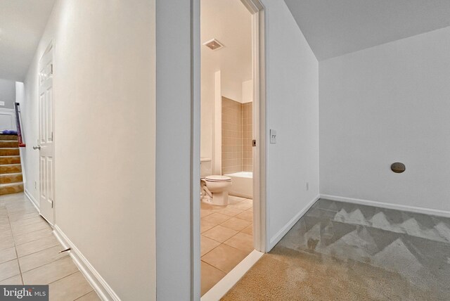 42667 New Dawn Ter, Brambleton, VA 20148 - hallway featuring light tile patterned flooring, stairs, baseboards, and light carpet