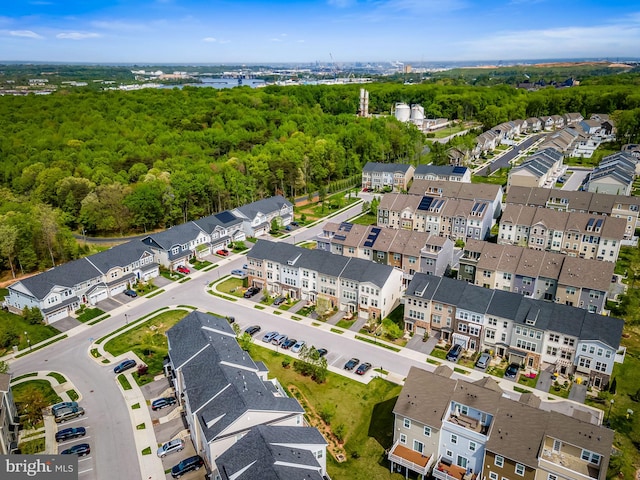 birds eye view of property featuring a view of trees