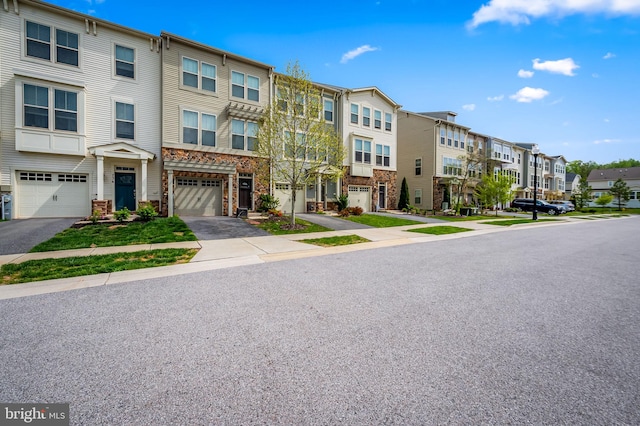exterior space with a residential view, an attached garage, and driveway
