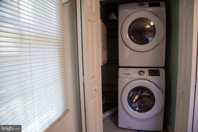washroom featuring laundry area and stacked washer / dryer