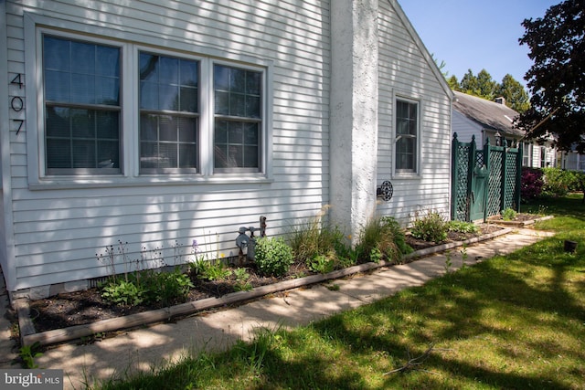 view of side of property featuring fence