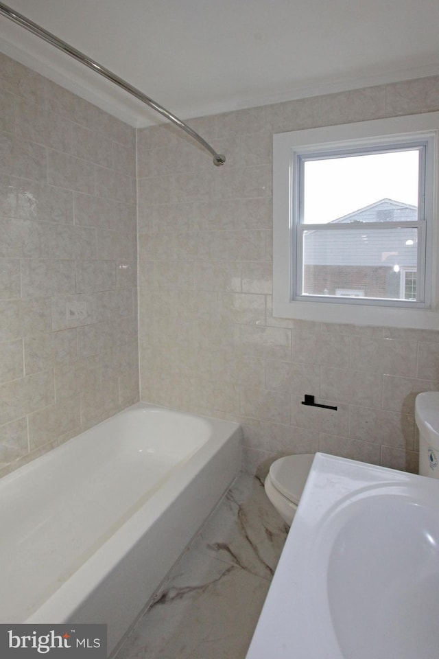 full bathroom featuring crown molding, tile walls, toilet, and marble finish floor