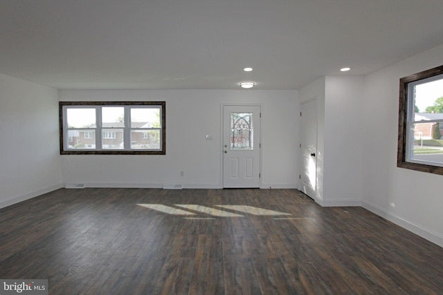interior space with recessed lighting, baseboards, and dark wood-type flooring