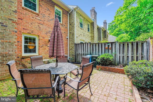 view of patio / terrace featuring outdoor dining space and fence