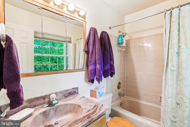 bathroom featuring shower / bath combo with shower curtain, toilet, and vanity