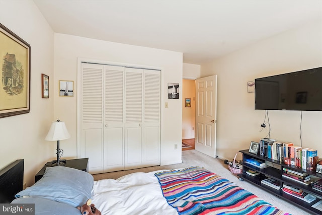 carpeted bedroom with a closet