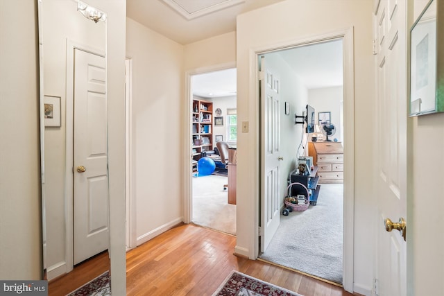 entryway with light wood-style flooring and baseboards