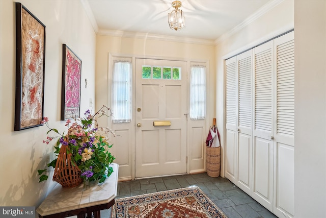 foyer entrance featuring crown molding and stone tile flooring