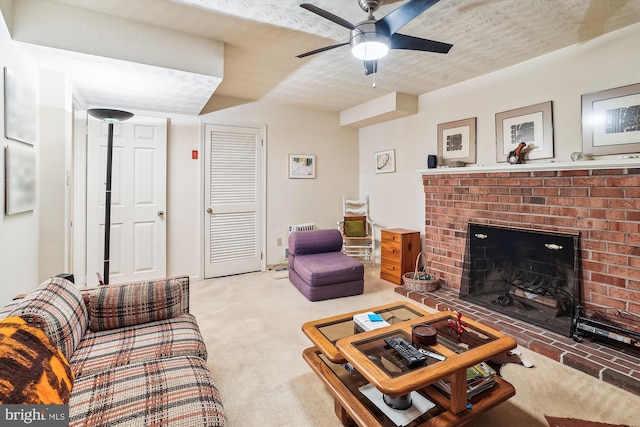 living area featuring a ceiling fan, a brick fireplace, and light colored carpet