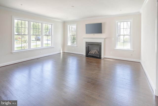 unfurnished living room with a fireplace with flush hearth, baseboards, dark wood-type flooring, and a wealth of natural light
