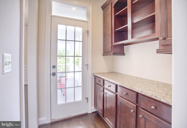 doorway to outside with baseboards and dark wood finished floors