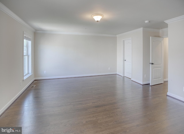 empty room with crown molding, baseboards, and dark wood-style floors