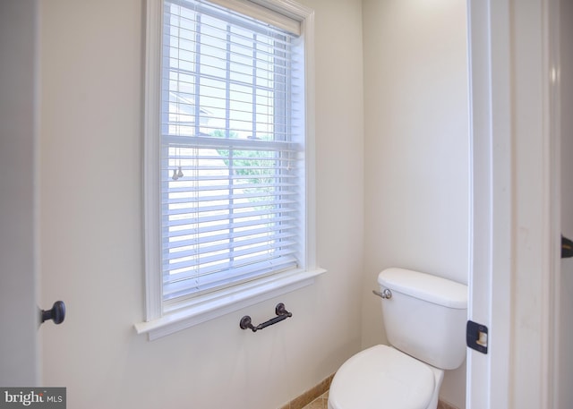 bathroom with toilet and baseboards