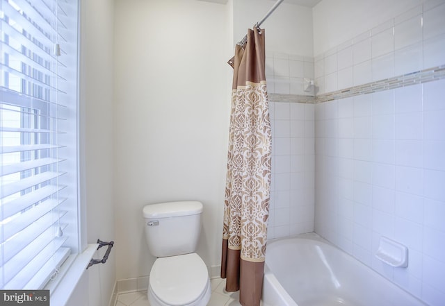 bathroom with tile patterned flooring, baseboards, toilet, and shower / tub combo
