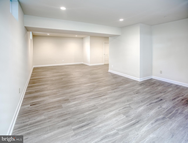 finished basement with recessed lighting, baseboards, and wood finished floors