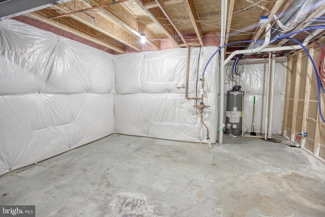 unfinished basement featuring water heater