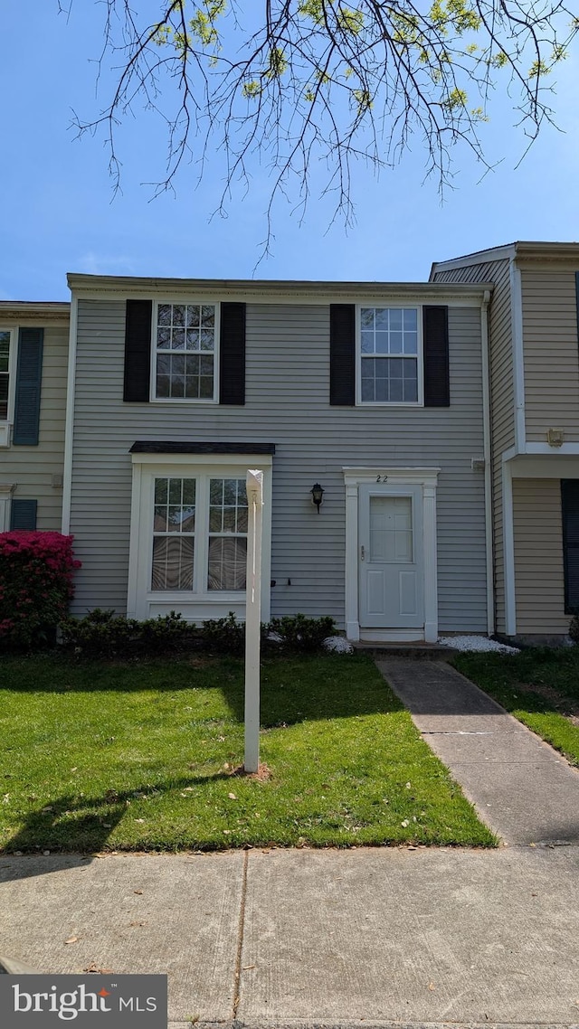 view of property featuring a front lawn