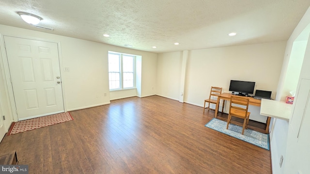 office with recessed lighting, a textured ceiling, and wood finished floors