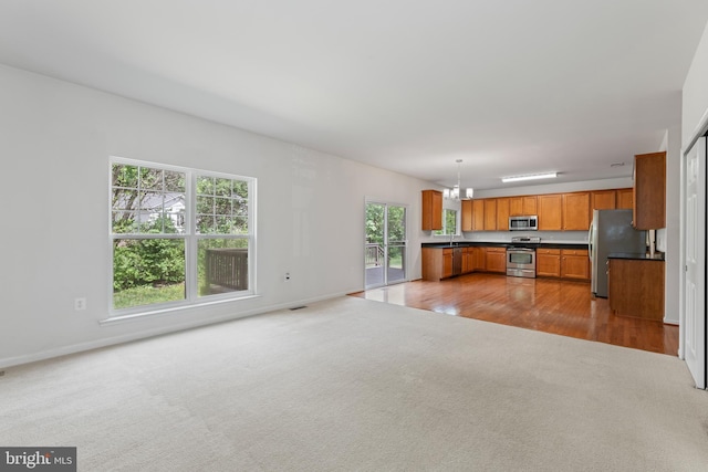 136 Roseville Ct, Boyce, VA 22620 - unfurnished living room with an inviting chandelier, baseboards, and light carpet