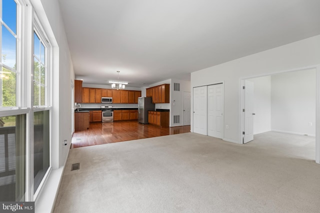 136 Roseville Ct, Boyce, VA 22620 - unfurnished living room with carpet floors, a chandelier, a sink, and visible vents