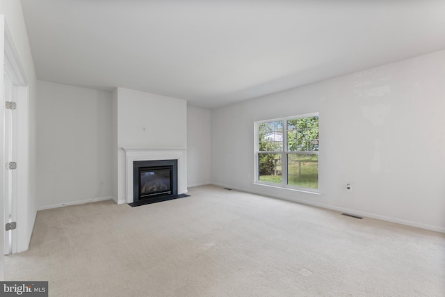136 Roseville Ct, Boyce, VA 22620 - unfurnished living room featuring visible vents, a fireplace with flush hearth, baseboards, and light carpet