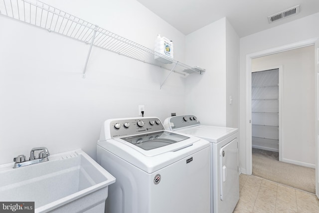 136 Roseville Ct, Boyce, VA 22620 - clothes washing area with laundry area, washing machine and clothes dryer, visible vents, a sink, and light carpet