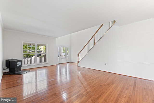 136 Roseville Ct, Boyce, VA 22620 - unfurnished living room featuring stairs, ornamental molding, wood finished floors, and a wood stove