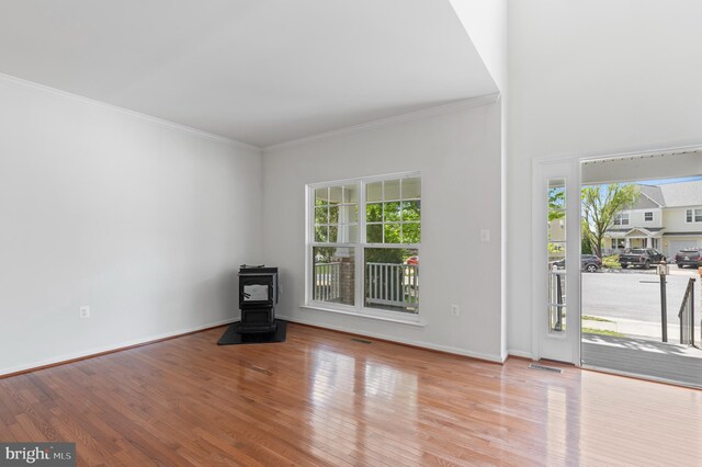 136 Roseville Ct, Boyce, VA 22620 - foyer with visible vents, a wood stove, ornamental molding, wood finished floors, and baseboards