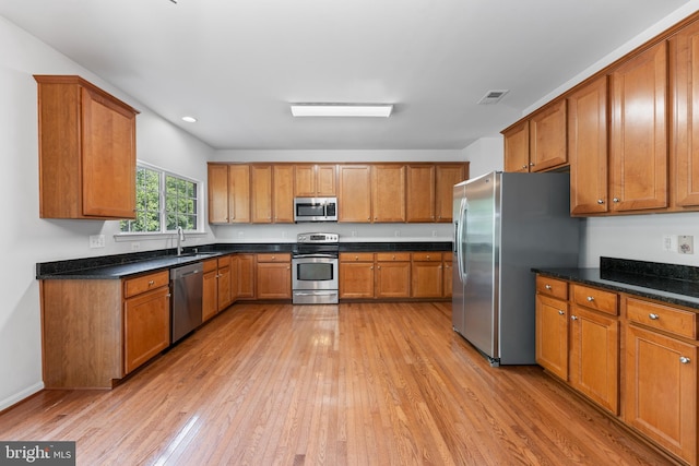 136 Roseville Ct, Boyce, VA 22620 - kitchen with appliances with stainless steel finishes, brown cabinetry, and a sink