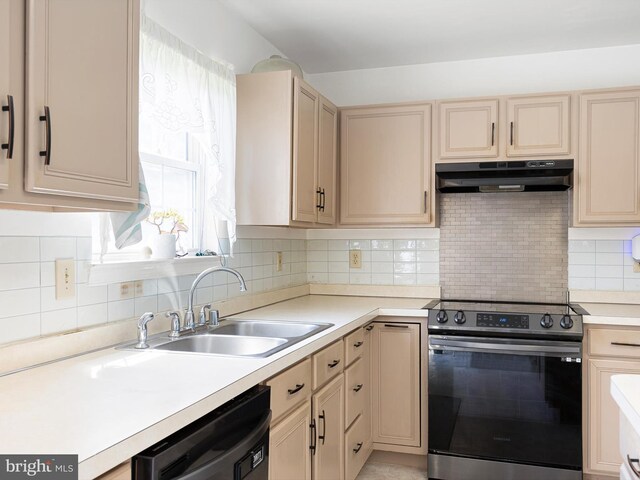 kitchen with tasteful backsplash, stainless steel range with electric cooktop, a sink, black dishwasher, and under cabinet range hood