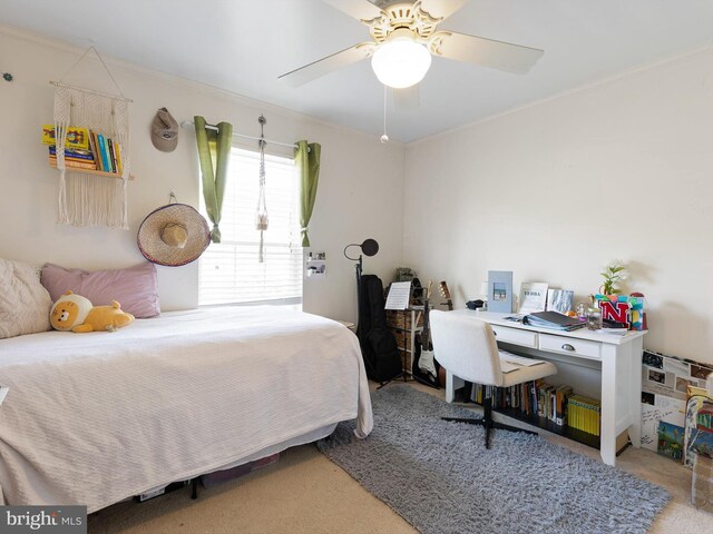 bedroom with crown molding, a ceiling fan, and carpet floors