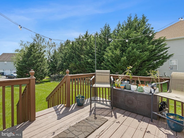 wooden deck featuring a lawn