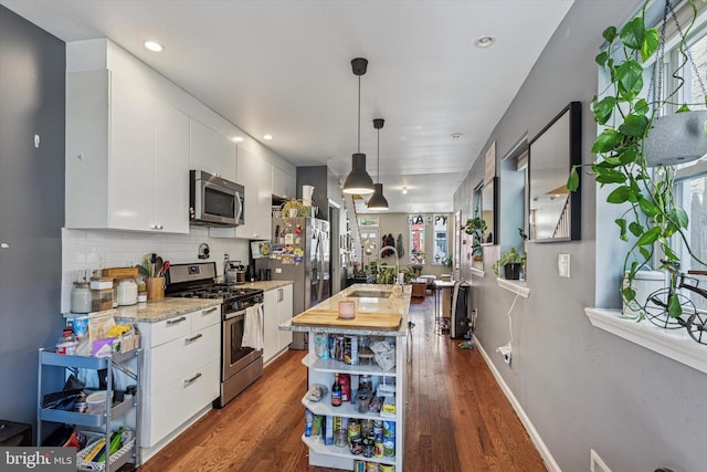 538 Moore St, Philadelphia, PA 19148 - kitchen with decorative backsplash, appliances with stainless steel finishes, open shelves, dark wood finished floors, and white cabinets