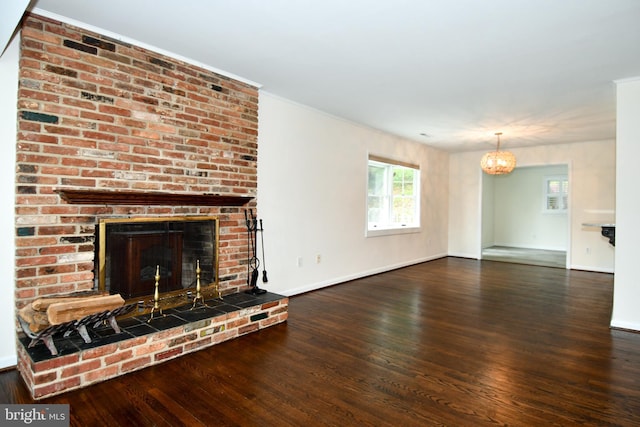 130 Great Lake Dr, Annapolis, MD 21403 - unfurnished living room featuring wood finished floors, a brick fireplace, baseboards, and a chandelier