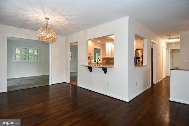 130 Great Lake Dr, Annapolis, MD 21403 - empty room with a chandelier, dark wood-style flooring, a sink, baseboards, and crown molding
